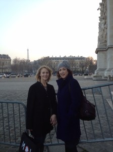 At the Arc de Triomphe with the Eiffel Tower in the background. 